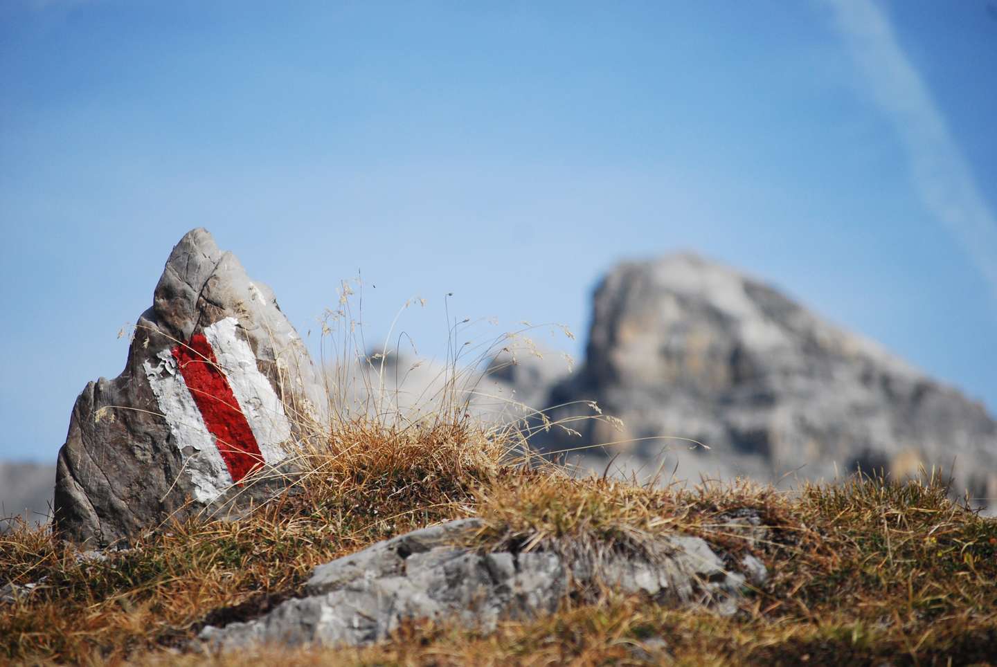 Stone marker with white-red-white flag on the trail