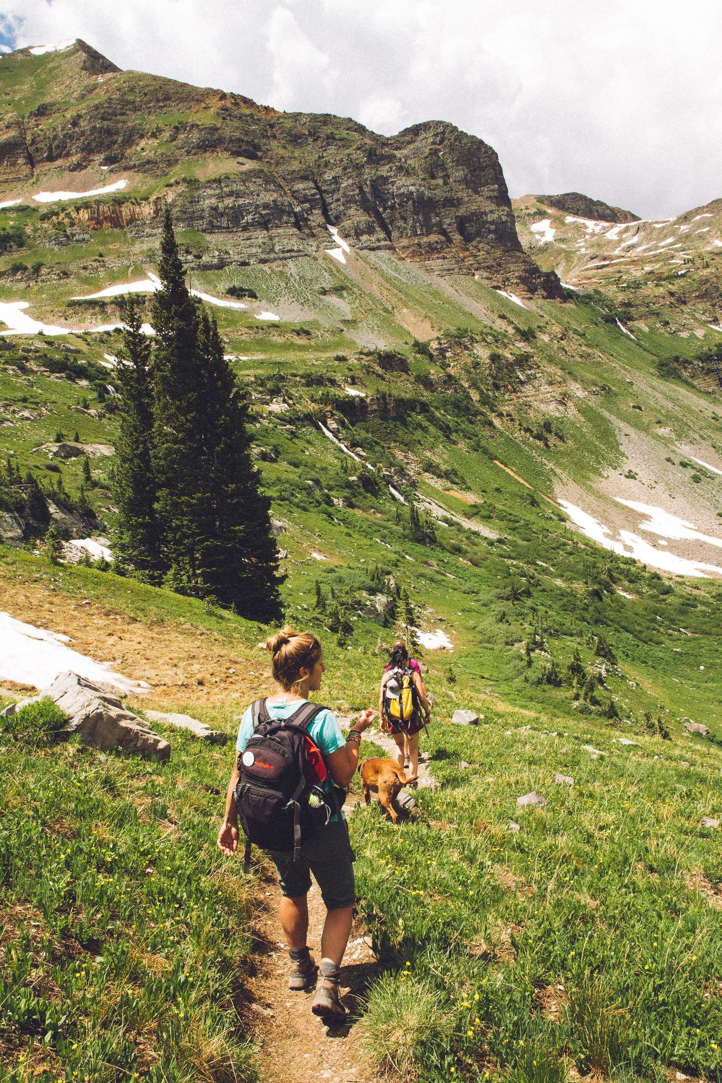 Family and dog going down the mountain